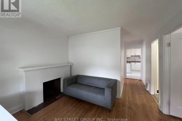 Empty room with white walls, a large window, and hardwood floors. - 125 Broadway Avenue, Hamilton