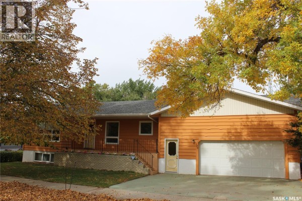 View from the front porch with wooden decking and railings, overlooking the street. - 125 Mainprize Street, Midale