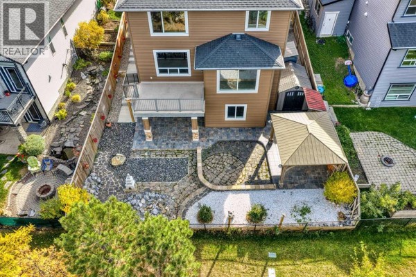 Balcony view overlooking landscaped yard and trees - 125 Seagreen Passage, Chestermere