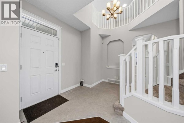 Spacious master bedroom with large window and neutral decor - 125 Seagreen Passage, Chestermere