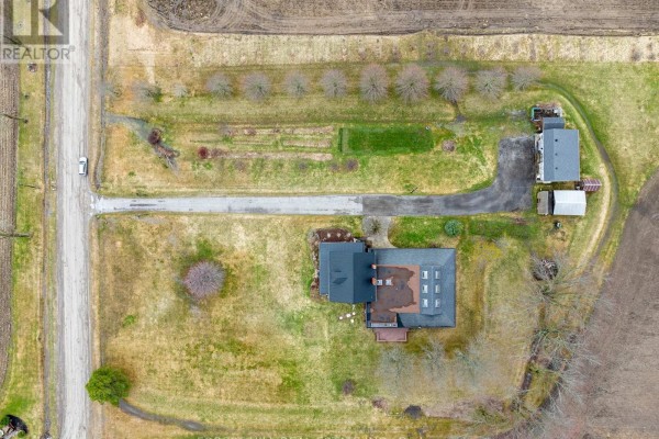 Overhead view of farm buildings and rural landscape with plowed fields. - 1251 Scugog Line 8, Scugog