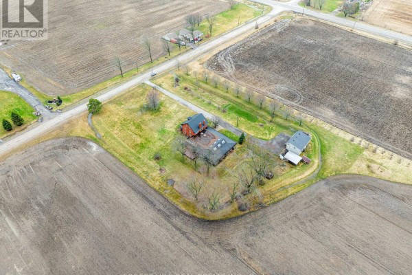 Aerial view of rural property with multiple buildings and surrounding fields. - 1251 Scugog Line 8, Scugog