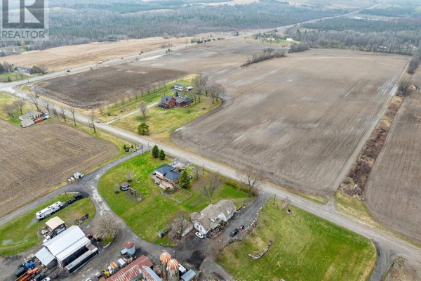 Aerial view of farmland, farm buildings, and a residential house. - 1251 Scugog Line 8, Scugog