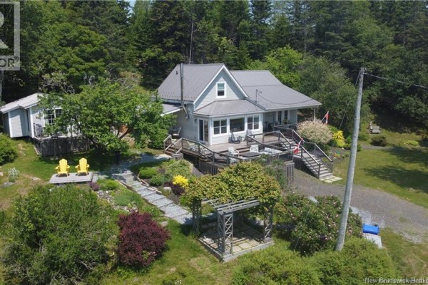 Aerial view of the property showing the house, deck, and landscaped yard - 1253 Rte 772, Cummings Cove