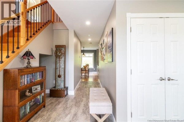 Entryway with wooden staircase, gray walls, and decorative shelving - 1253 Rte 772, Cummings Cove