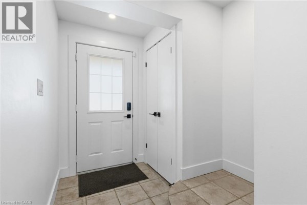 Entrance to 'Dawn of Angels Health Inc.' commercial unit with stone accents and signage. - 1253 Silvan Forest Drive Unit# 7, Burlington