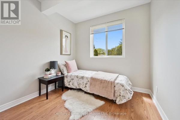 Second-floor hallway with wooden railing and neutral walls - 126 Forfar Street E, Centre Wellington