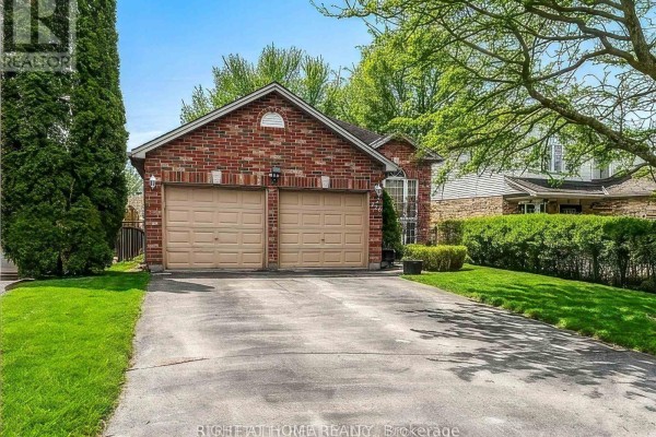 Close-up of driveway and garage with green lawn - 126 Meadowridge Road, London North