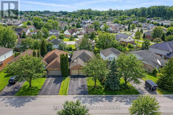 Aerial view of neighborhood with houses and trees - 126 Meadowridge Road, London North