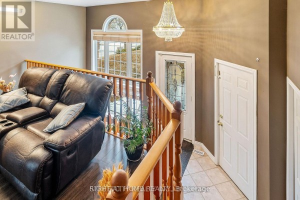 Interior view of entryway with chandelier and seating area - 126 Meadowridge Road, London North