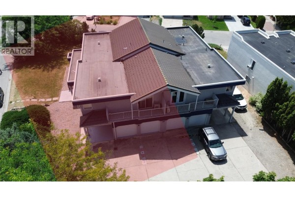 Aerial view highlighting the lot boundary and the duplex exterior. - 126 Verna Court, Kelowna