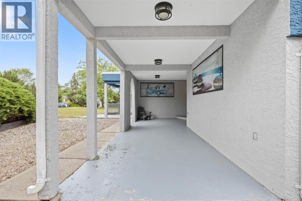 Covered patio area with concrete floor and grey painted columns. - 126 Verna Court, Kelowna