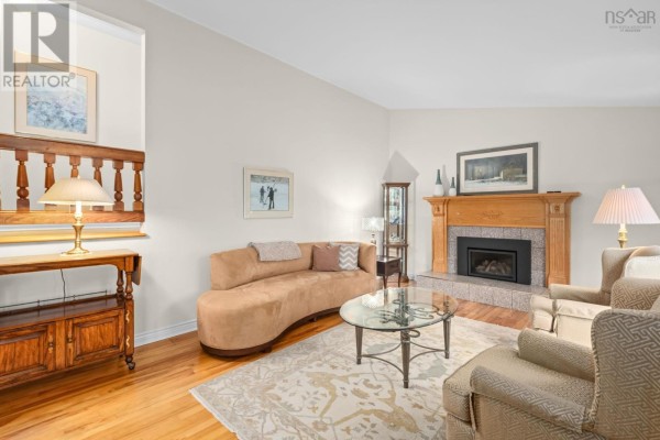 Living room featuring a fireplace, hardwood floors, and plush seating. - 127 Evans Avenue, Halifax