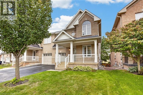 Open-concept dining and living room with hardwood floors and a fireplace. - 127 Knapton Drive, Newmarket