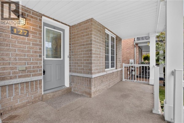 Living room with a fireplace, seating, and a display cabinet. - 127 Knapton Drive, Newmarket