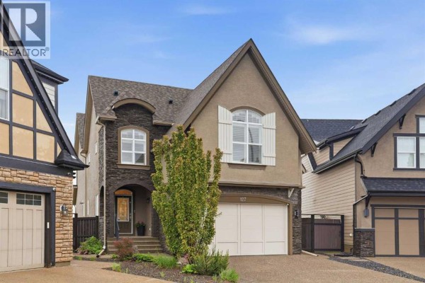 Back deck with patio furniture and view of surrounding landscape. - 127 Marquis Grove Se, Calgary