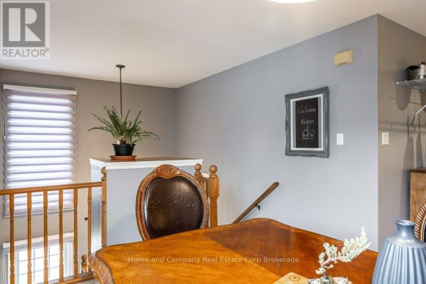 Living room with fireplace, glass coffee table, sofa, and bookshelf - 127 Walsh Crescent Stratford