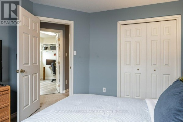 Townhouse exterior with brick facade, double garage, and front entrance - 127 Walsh Crescent Stratford