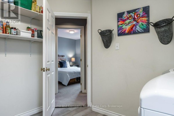 Front exterior of a brick townhouse with attached garage and wreath on door - 27 Walsh Crescent Stratford