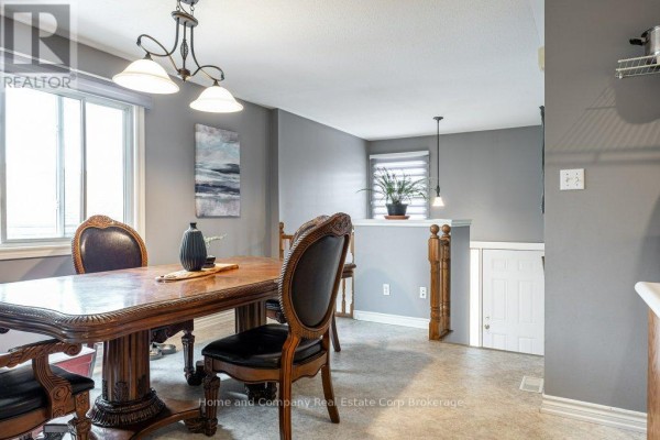 Hallway with open bedroom door, cat painting, and laundry machine - 127 Walsh Crescent Stratford
