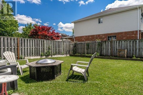 Kitchen island, dining table, and pot rack with cookware - 127 Walsh Crescent Stratford
