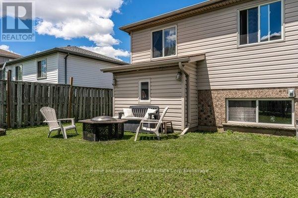 Brick house exterior with covered entrance, garage, and wooden fence - 127 Walsh Crescent Stratford