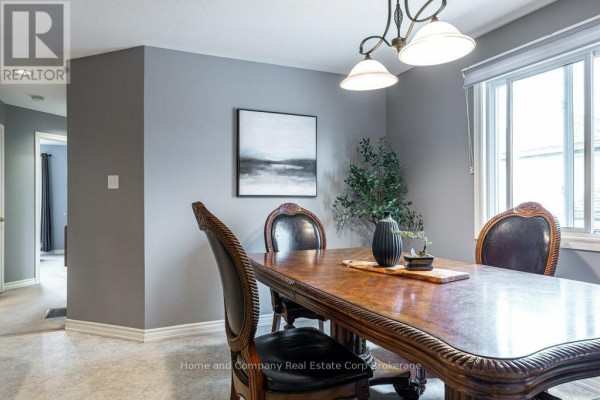 Staircase with patterned risers and wood banister beside a white door - 127 Walsh Crescent Stratford
