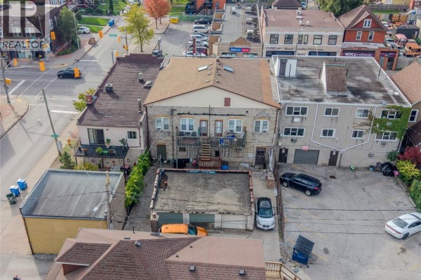 Aerial view of the rear of the property showing multiple garages and backyards. - 1276-1282 Wyandotte Street East, Windsor