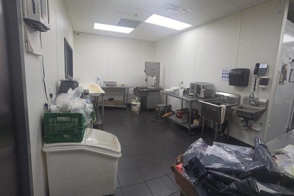 Wide-angle view of the restaurant interior showing a counter with a POS system, display cases, and seating area. - 12760 Hwy 50 A2 Highway, Caledon