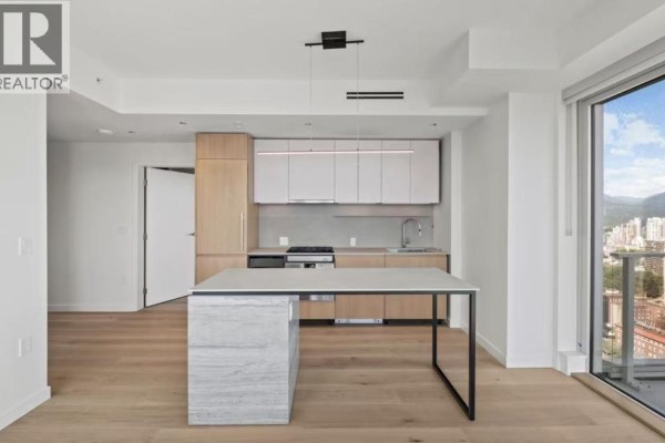 Open concept kitchen and living area with light wood flooring and a large window overlooking the city. - 1277 Hornby Street, Vancouver