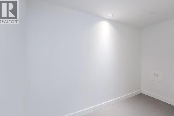 Interior shot of a room with plain white walls and a recessed ceiling light. - 1277 Hornby Street, Vancouver