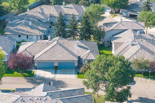 Aerial view of a suburban street lined with duplexes and mature trees. - #128 215 Blackburn East Dr Sw, Edmonton