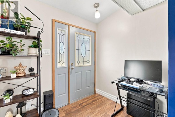 Entranceway with a grey double door, wood floors, and a computer desk. - 128 Boehmer Blvd, Sault Ste  Marie