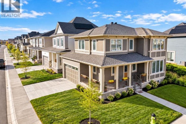 Street view of a suburban neighborhood with houses on both sides of the street. - 128 Cityside Crescent Ne, Calgary