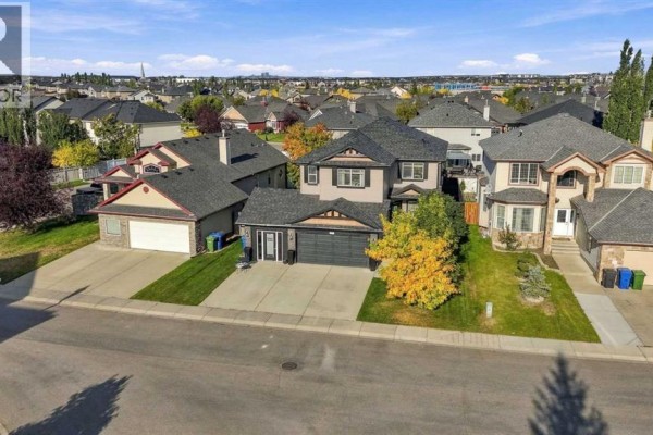 Aerial view of a two-story house on a street with surrounding residential properties. - 128 Seagreen Way, Chestermere