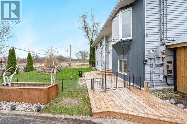 White kitchen cabinets, refrigerator, stove, and backsplash tile with view of staircase. - 12804 County Road 16, Severn