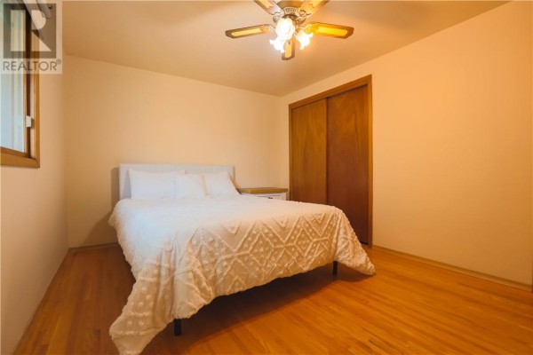 Bedroom with a bed, closet, and hardwood floors - 1295 Gemmell Street Sudbury