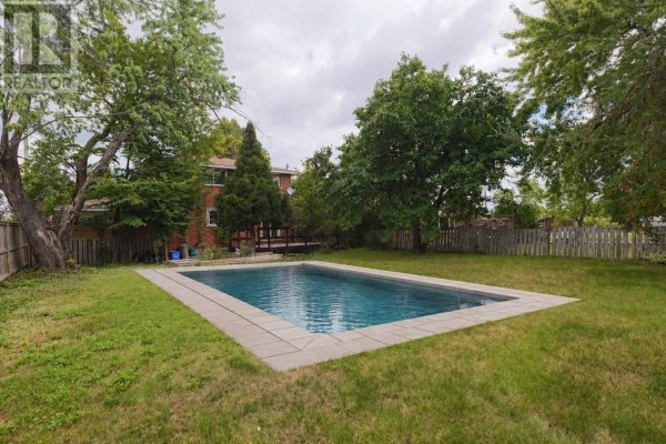 Inground pool with concrete surround, deck, and trees - 1295 Gemmell Street Sudbury