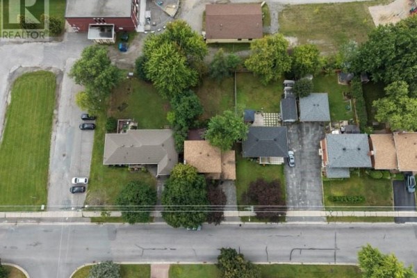 Aerial view of suburban homes and apartment building with paved driveway and mature trees - 1295 Gemmell Street Sudbury