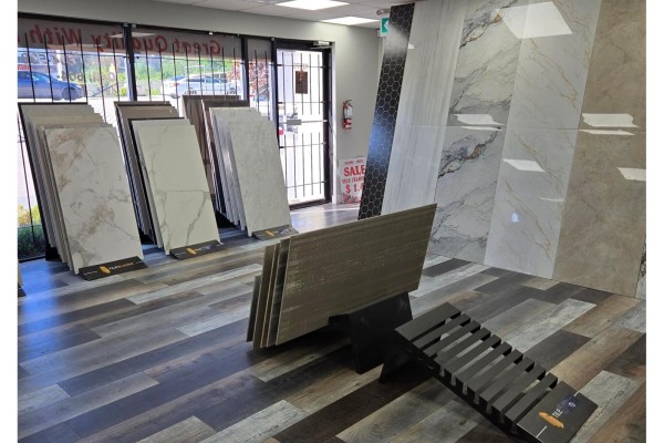 Showroom with standing tile displays, a bench, and a view through the front windows. - 12975-12977 80 Avenue, Surrey