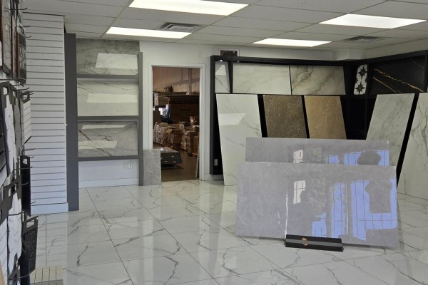 View of showroom corner with tile displays and a glimpse into the warehouse storage area. - 12975-12977 80 Avenue, Surrey
