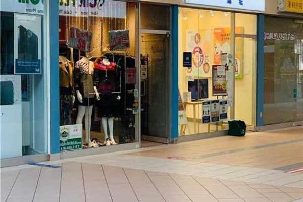 Storefronts in an indoor mall corridor with mannequins in a clothing store window display. - 129a - 3255 Highway 7 E, Markham