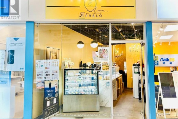 Interior view of a cafe with display cases filled with pastries and seating area. - 129a - 3255 Highway 7 E, Markham