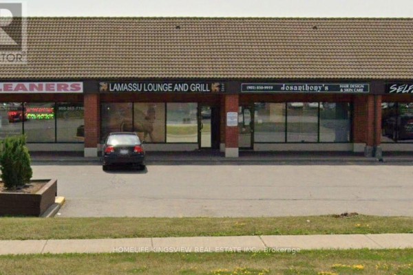 A row of commercial storefronts including Lamassu Lounge and Grill under a tiled roof. - 13 - 200 Marycroft Avenue E, Vaughan