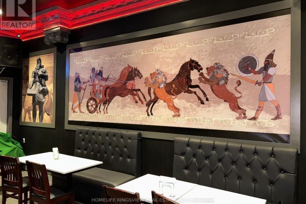 Dining area with black tufted booths, white tables, and a large Egyptian-themed mural. - 13 - 200 Marycroft Avenue E, Vaughan