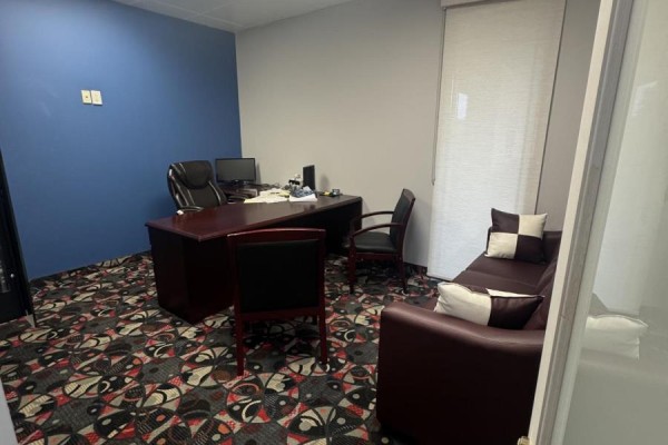 Office room with a dark wood desk, computer, chairs, and brown sofa. - 13 - 250 Wyecroft Road, Oakville