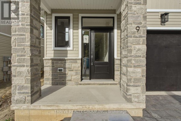 Close-up of a townhouse front door with stone pillar accents and a black door. - 13 - 279 Hill Street, Central Elgin