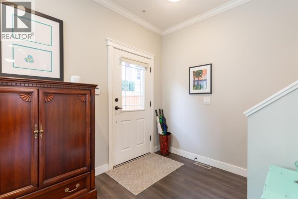 Street view of a townhouse complex with attached garages and manicured landscaping. - 13 10480 248 Street, Maple Ridge