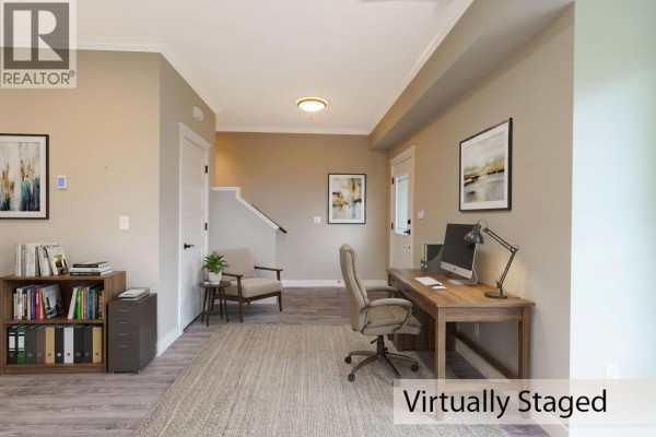 Home office space with desk, chair, and bookshelves against the wall - 13 10550 248 Street, Maple Ridge