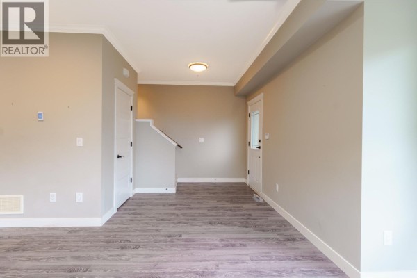 Empty room with staircase and door leading outside - 13 10550 248 Street, Maple Ridge